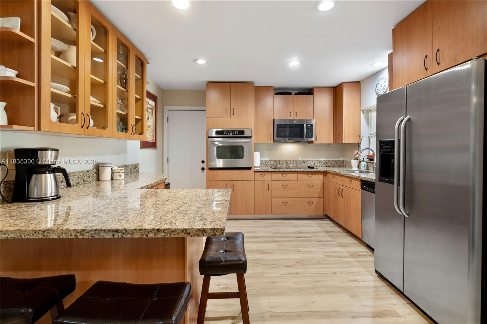 4025 Washington Street Hollywood, FL 33021 - Photo 6 of 24 a large kitchen with granite countertop lots of counter space and stainless steel appliances