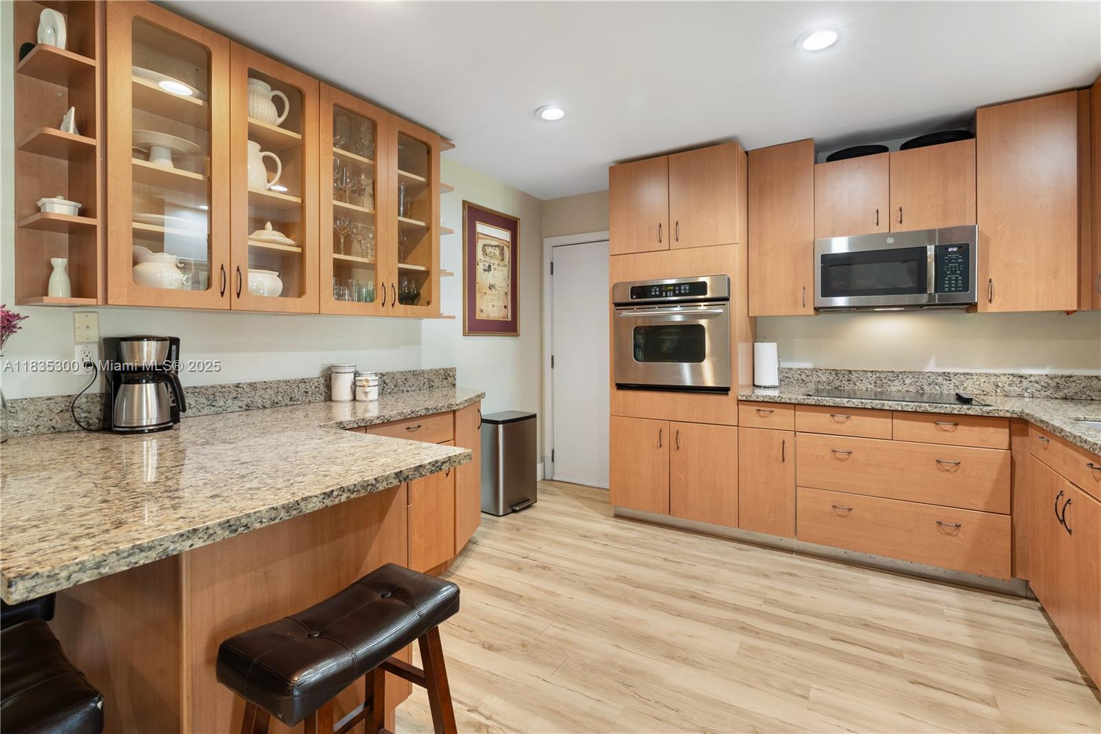 4025 Washington Street Hollywood, FL 33021 - Photo 8 of 24 a kitchen with stainless steel appliances granite countertop a sink wooden cabinets and a granite counter tops