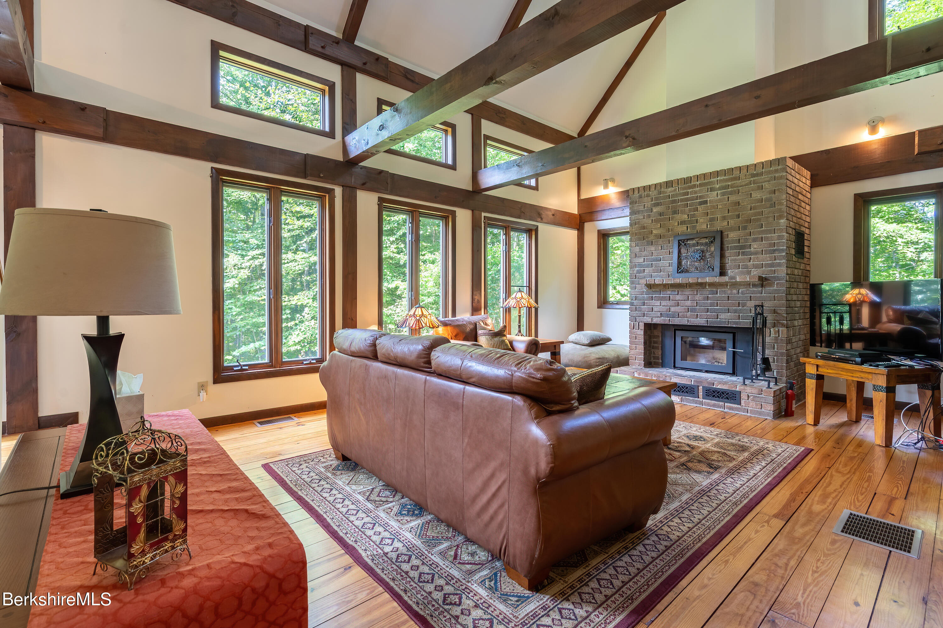 161 Capt Whitney Road Becket, MA 01223 - Photo 4 of 29 a living room with furniture fireplace and a large window