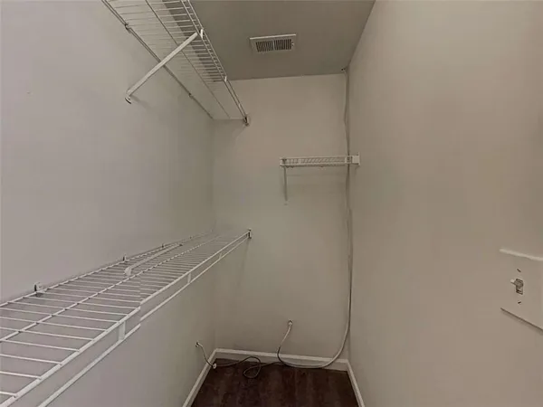 a view of storage and utility room with racks on the wall