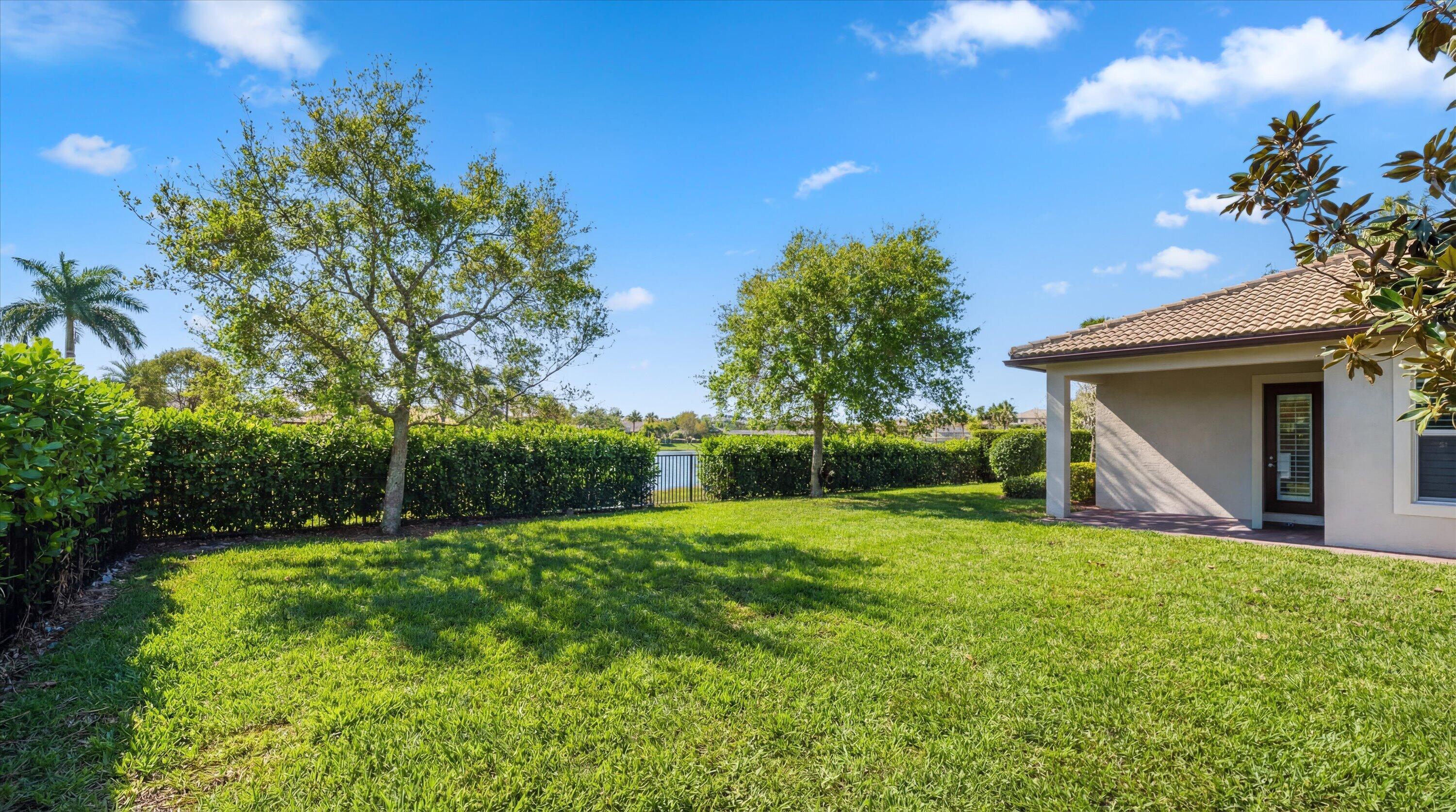 108 Casa Circle Jupiter, FL 33458 - Photo 34 of 53 a view of a back yard of the house