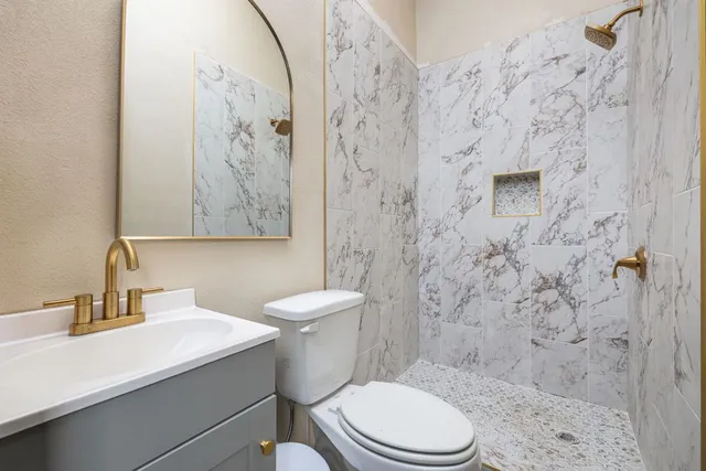 a white toilet sitting next to a bathroom sink