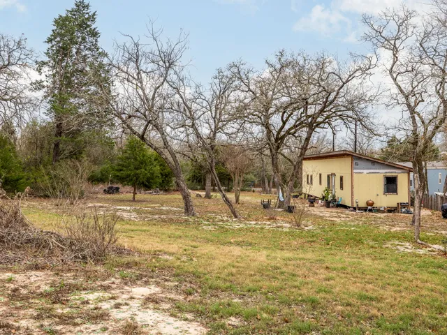 a view of a house with a yard covered with snow in front of house