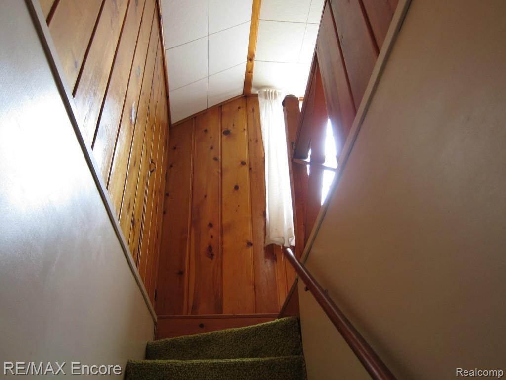 1424 North Genesee Road Burton, MI 48509 - Photo 12 of 26 Knotty Pine Stairwell to upstairs