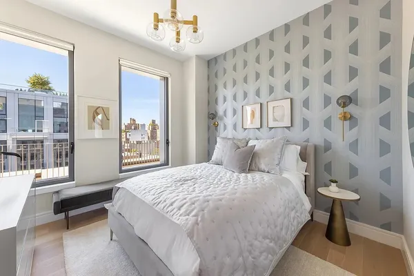 a bedroom with a bed and a chandelier