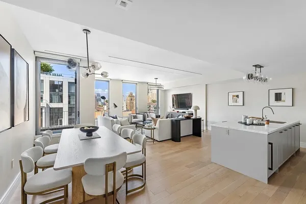 a view of a dining room with furniture and chandelier