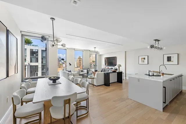 a view of a dining room with furniture and chandelier