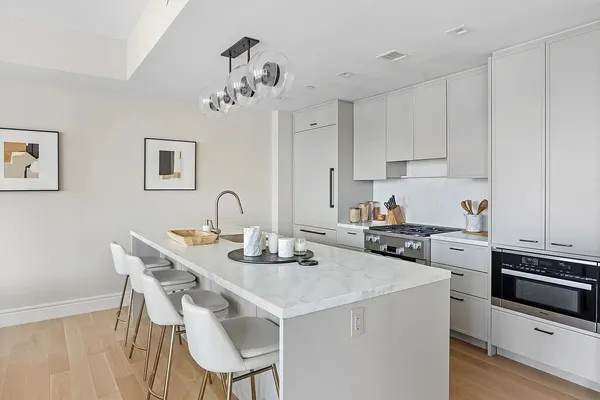 a kitchen with a dining table chairs and stove