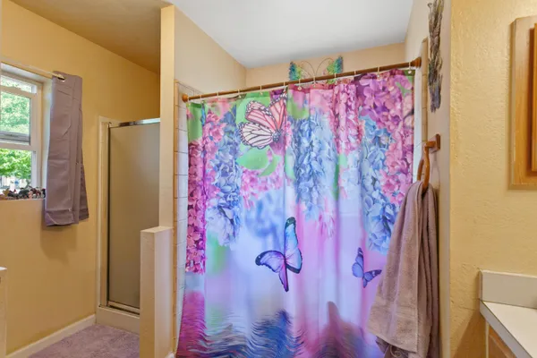 a bathroom with a bathtub and shower curtain