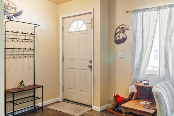 a view of a room with rack on the wall and a window