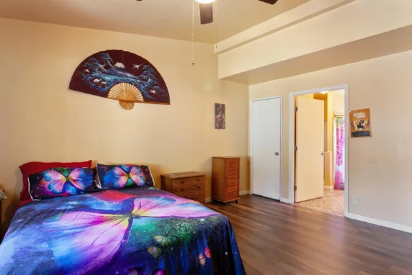 a bedroom with a bed and wooden floor