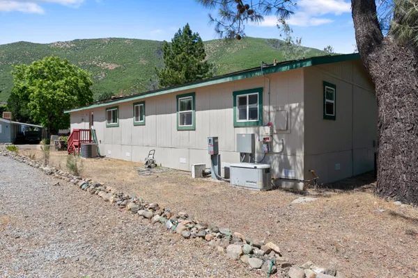 a view of a house with a backyard