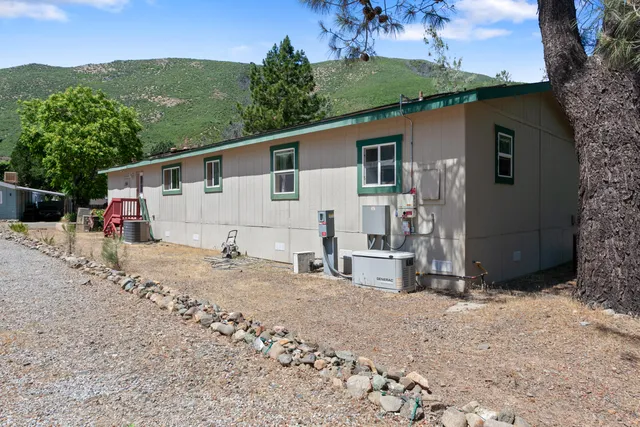 a view of a house with a backyard