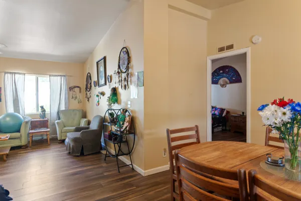 a living room with furniture and flowers