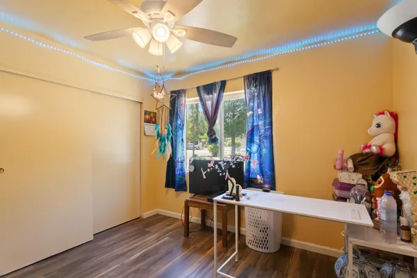 a view of a workspace with furniture and a window