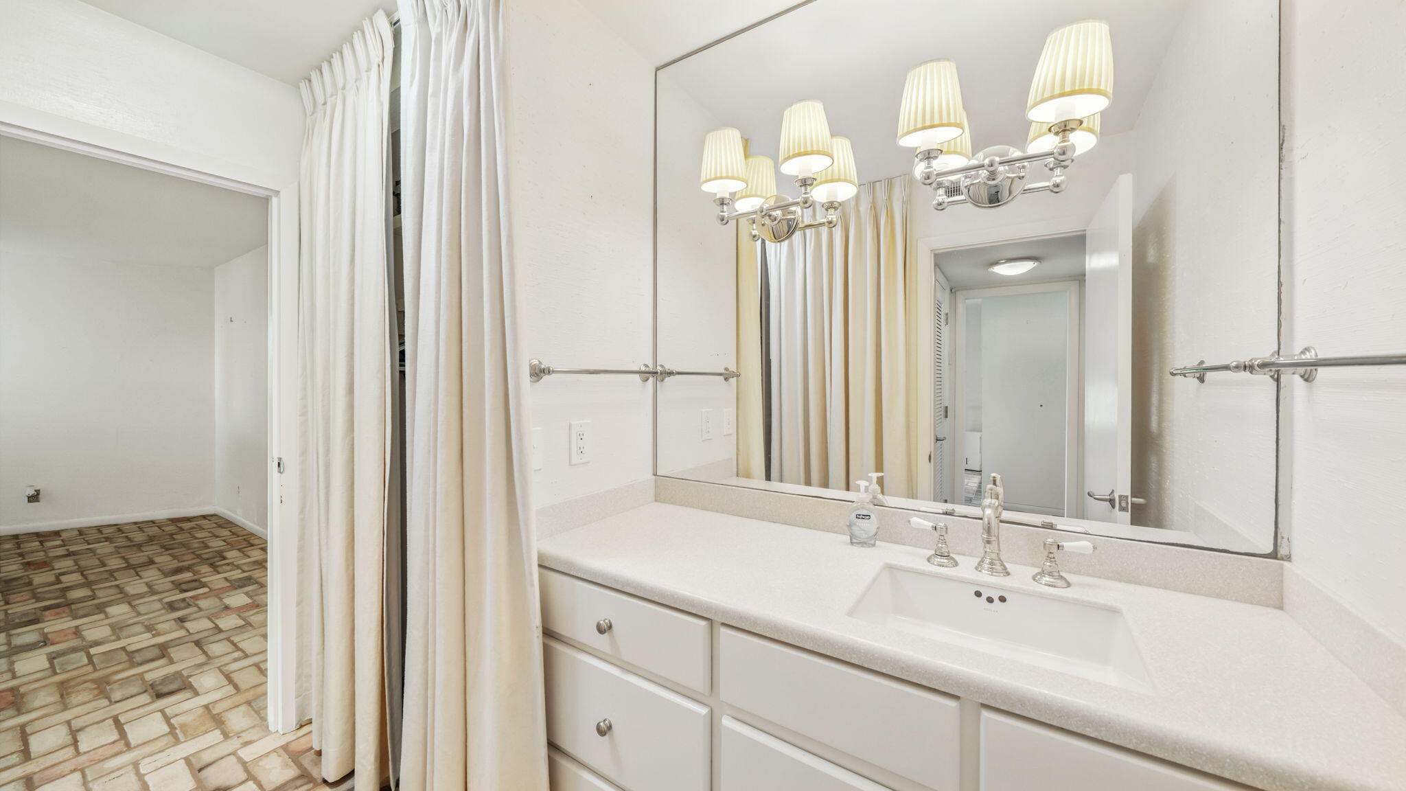 4725 Bay Point Road, Unit 166 Panama City Beach, FL 32408 - Photo 11 of 24 a bathroom with a double vanity sink and a mirror