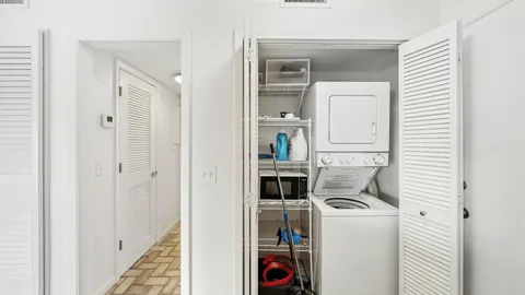 a view of storage and utility room with washer and dryer