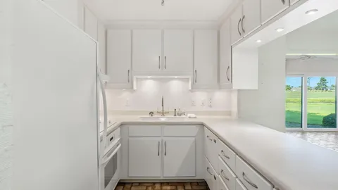 a kitchen with a sink cabinets and window