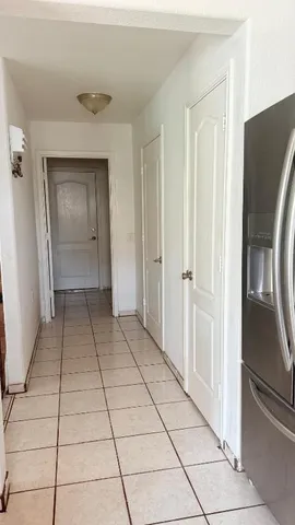 a view of an empty room and closet area