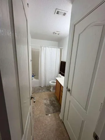 a view of a bathroom with a sink a mirror and a shower