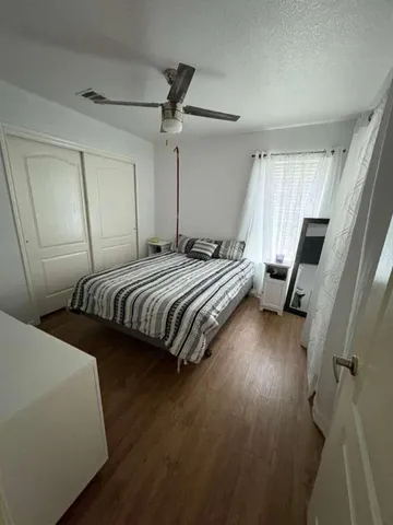 a bedroom with bed and window