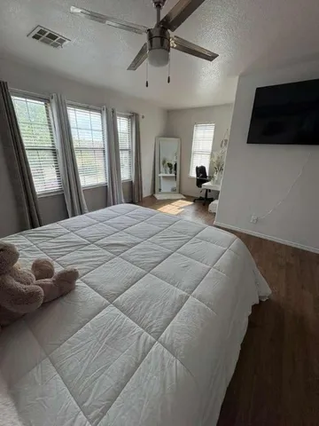 a bedroom with a large bed and a window