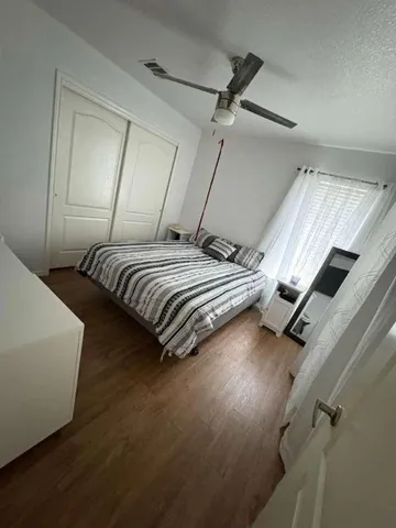 a bedroom with bed and window