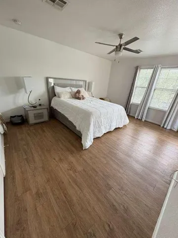 a bedroom with a bed and window