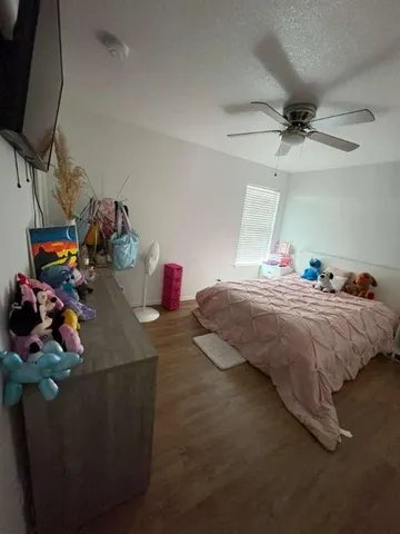 a bedroom with bed and a flat tv screen