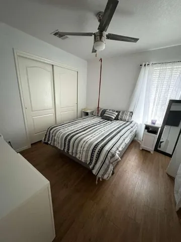 a bedroom with bed and window