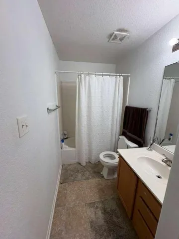 a white toilet sitting next to a bathroom sink