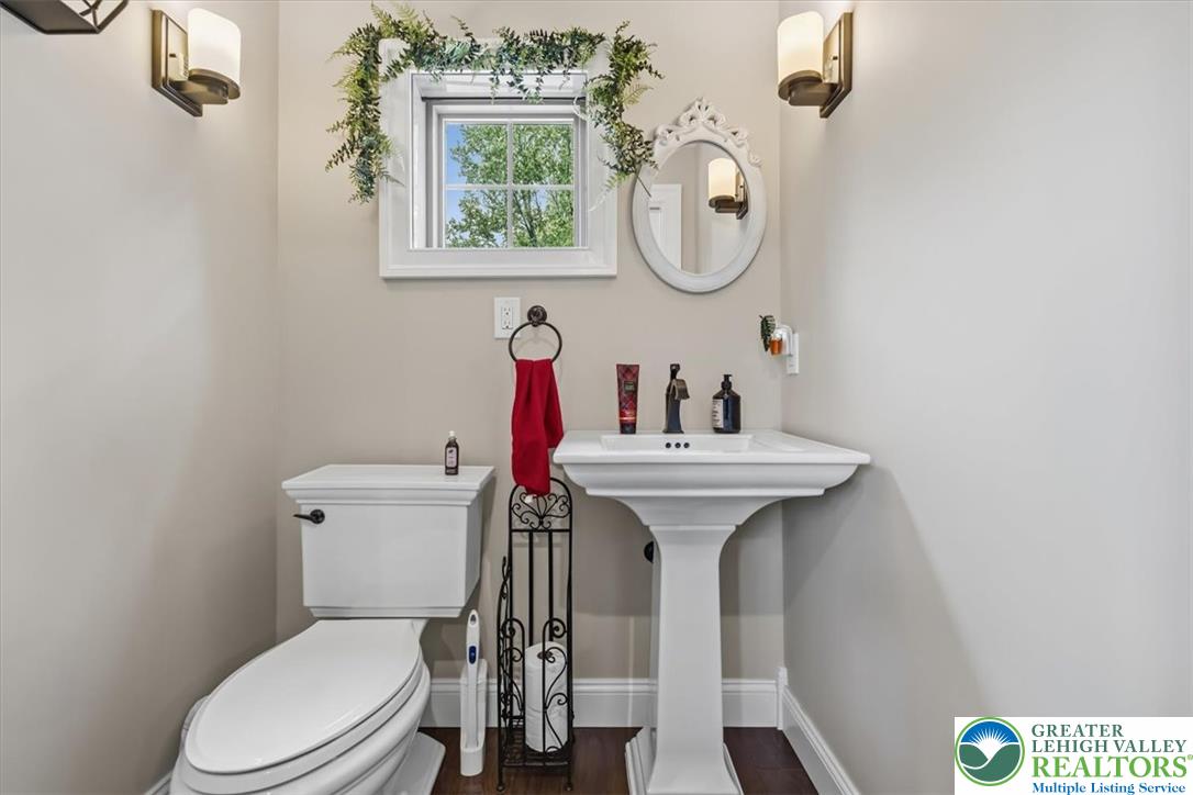 3771 State Road Coopersburg, PA 18036 - Photo 33 of 37 A classic pedestal sink paired with rich hardwood flooring anchors this cozy powder room.