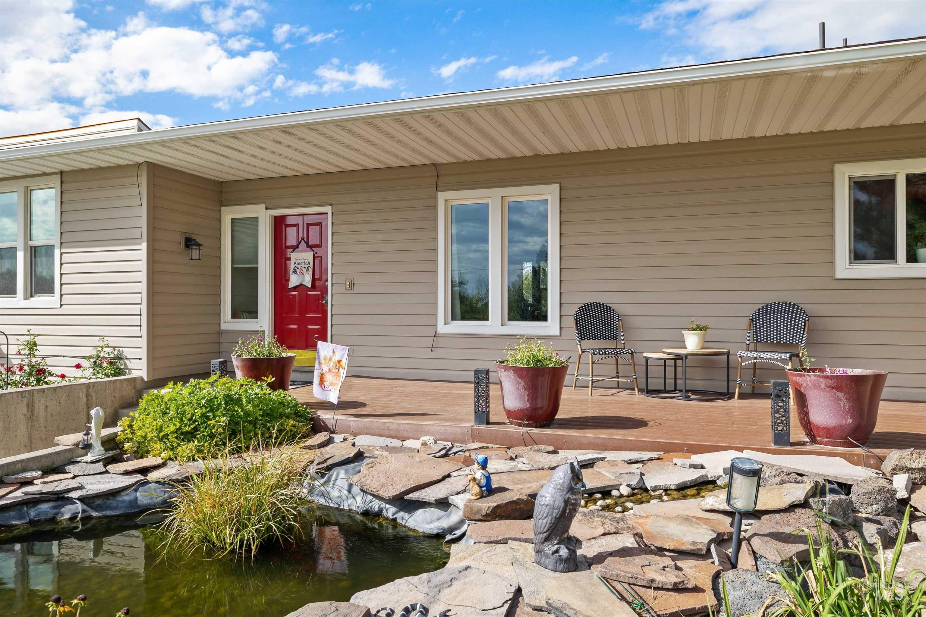 Wood-finish deck with a vibrant red entry door