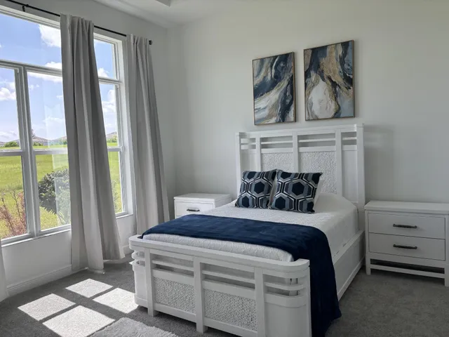 a bedroom with a bed and a dresser