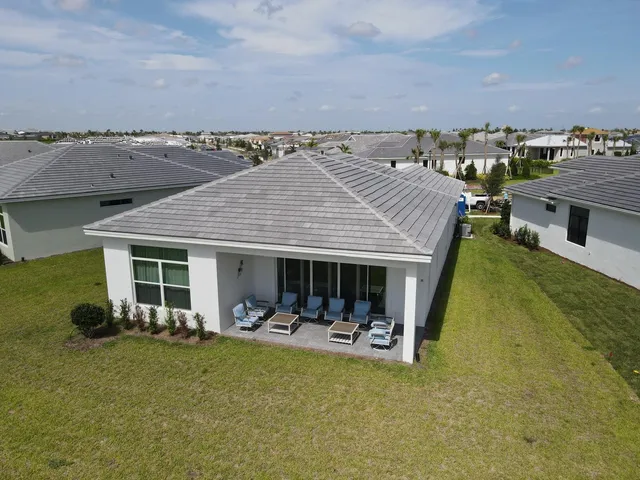 an aerial view of a house with table and chairs