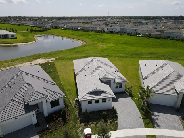 an aerial view of a house with a garden and swimming pool