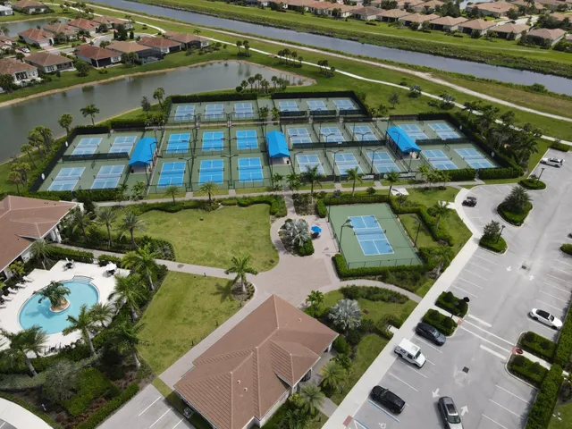an aerial view of residential houses with outdoor space and river view