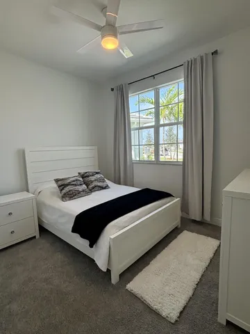 a spacious bedroom with a bed and a window