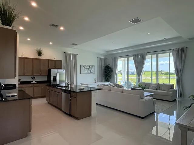 a living room with kitchen furniture and a large window