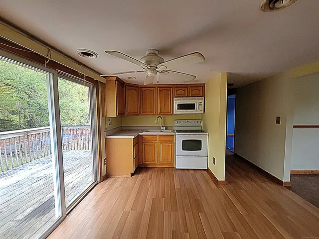 a kitchen with stainless steel appliances a stove top oven and a refrigerator