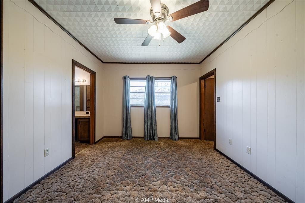 506 East Beauregard Street Rotan, TX 79546 - Photo 13 of 25 wooden floor in an empty room with a window