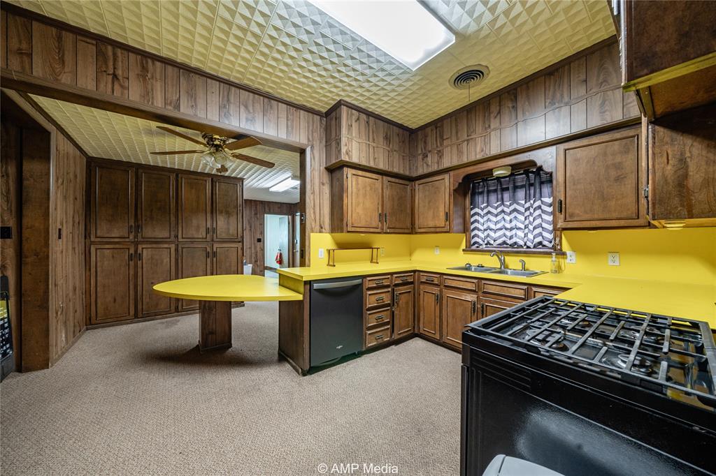 506 East Beauregard Street Rotan, TX 79546 - Photo 18 of 25 a kitchen with a sink and a stove
