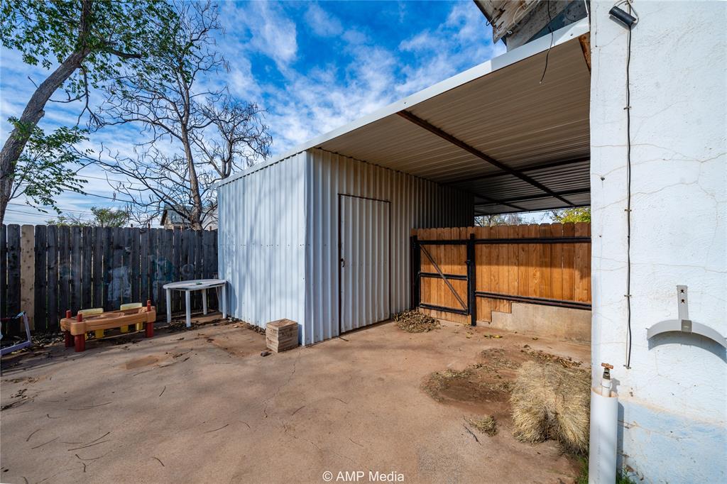 506 East Beauregard Street Rotan, TX 79546 - Photo 24 of 25 a view of backyard with small cabin and furniture