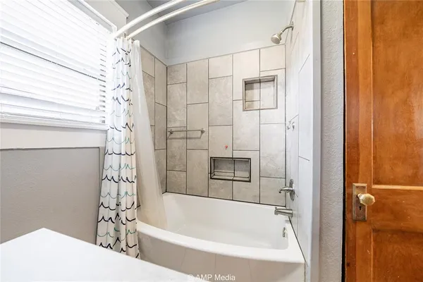 a bathroom with a bathtub and a shower