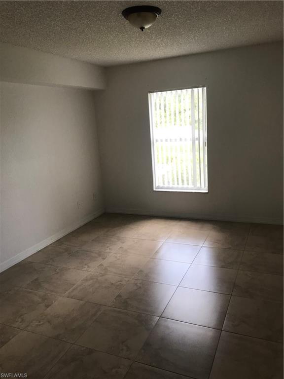 8245 Ibis Club Drive, Unit 409 Naples, FL 34104 - Photo 11 of 18 an empty room with a window
