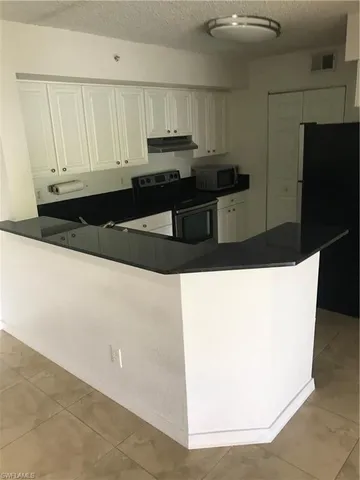 a kitchen with stainless steel appliances a refrigerator and sink