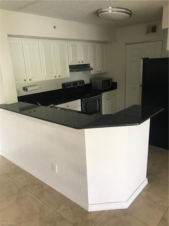 8245 Ibis Club Drive, Unit 409 Naples, FL 34104 - Photo 15 of 18 a kitchen with stainless steel appliances a refrigerator and sink