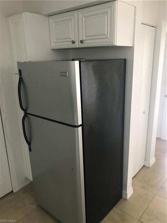 8245 Ibis Club Drive, Unit 409 Naples, FL 34104 - Photo 16 of 18 a view of cabinets and refrigerator