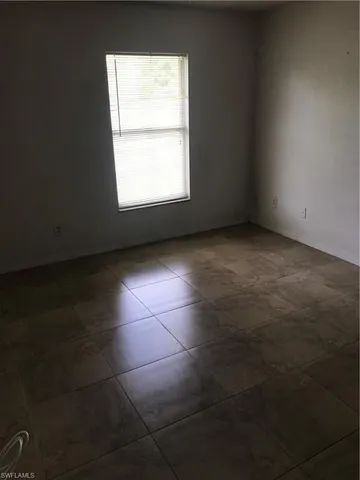 an empty room with a empty space and a window