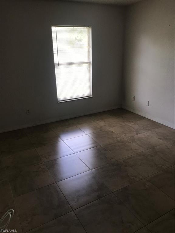 8245 Ibis Club Drive, Unit 409 Naples, FL 34104 - Photo 4 of 18 an empty room with a empty space and a window